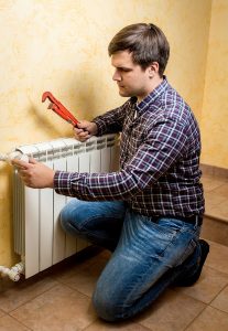 male technician working on radiator