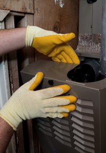 technicians hands working on heater