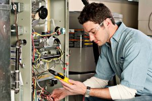 Service-technician-testing-a-furnace