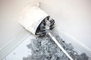 duct-being-cleaned-out-and-lint-surrounding-it