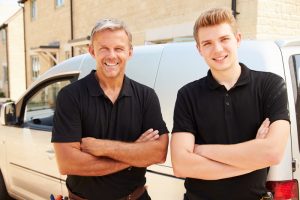 two-hvac-technicians-smiling-at-camera