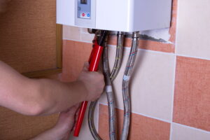 technicians-hands-repairing-tankless-water-heater