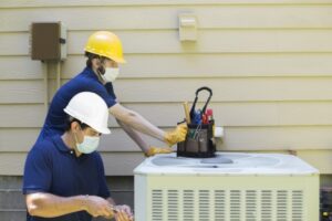 two-technicians-working-on-outside-unit