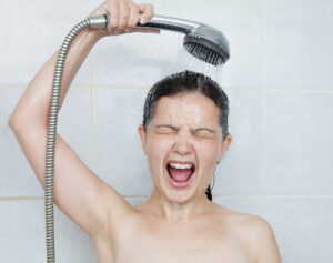 girl-holding-handheld-shower-head-with-cold-water