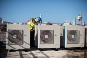 air conditioning installation on rooftop with technician