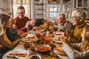 multi-generational-family-gathered-around-table-for-thanksgiving