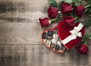 roses-and-chocolates-on-wood-tabletop