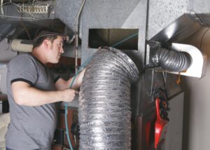 HVAC-technician-cleaning-ducts